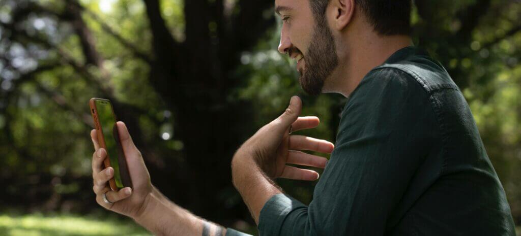 A man smiling while talking on his phone